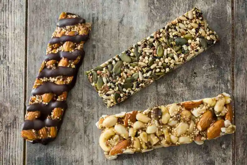 mixed dry fruits bars on a wooden table