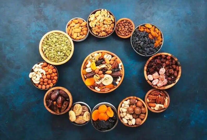 Mixed Dry Fruits for Energy in a bowl on blue background.