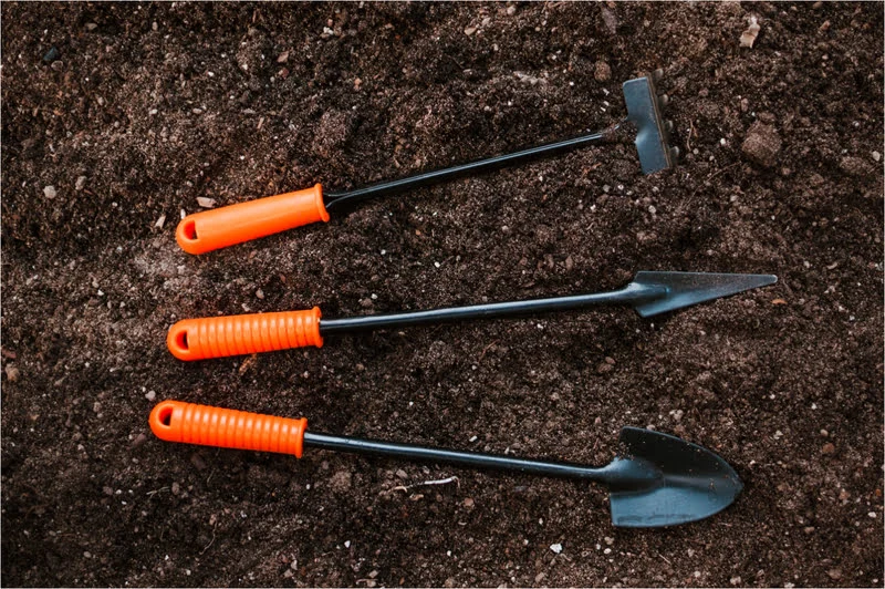 three Gardening Digging tools on the soil or mud