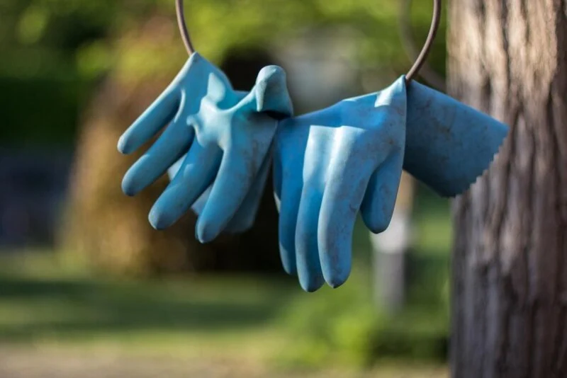 Gardening Gloves hanging on a wire.