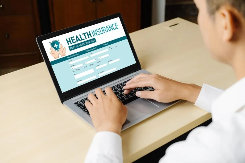 person reviewing health insurance options online here 